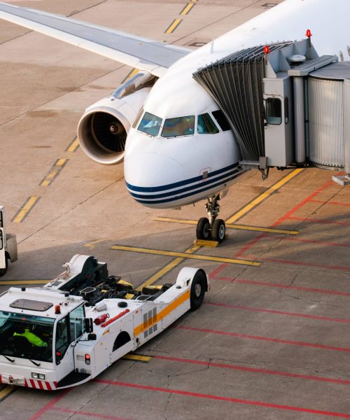 Airport. Airplane is being serviced by the ground crew.